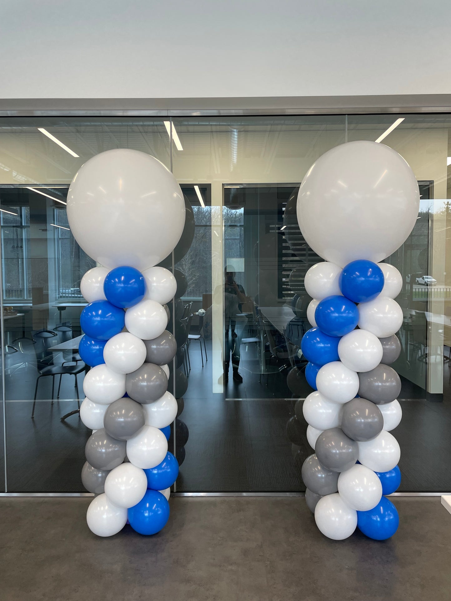 blue and white corporate tower balloons