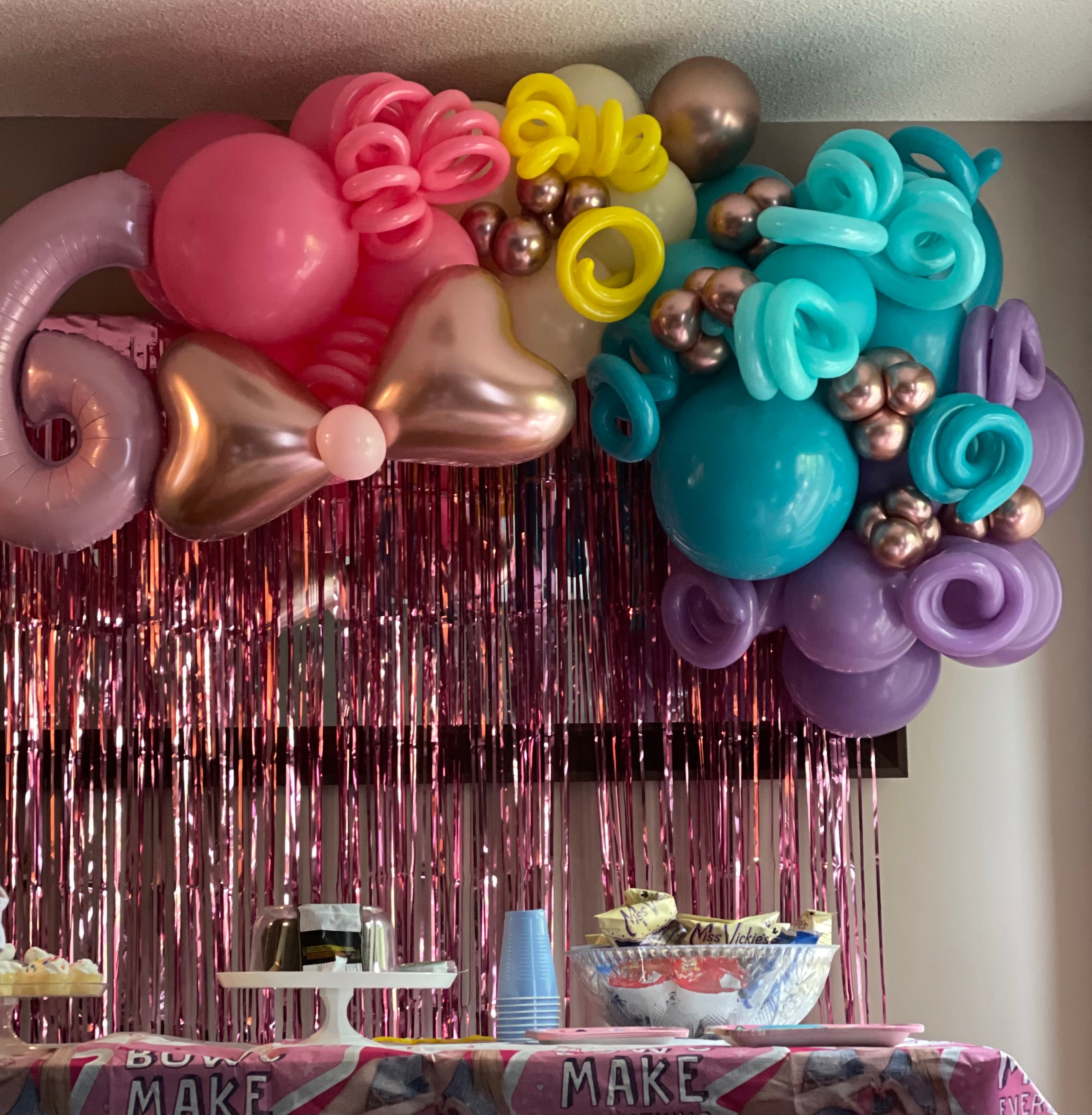 Organic balloon wall display with bright colours.